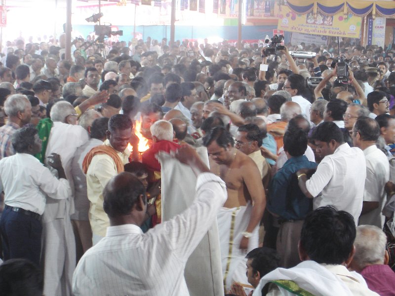 DSC03306.JPG - Rasikas reach for the aarti after the singing of the kritis is completed